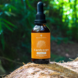 Mycocentrics Cordyceps tincture bottle on a mossy log in a forest