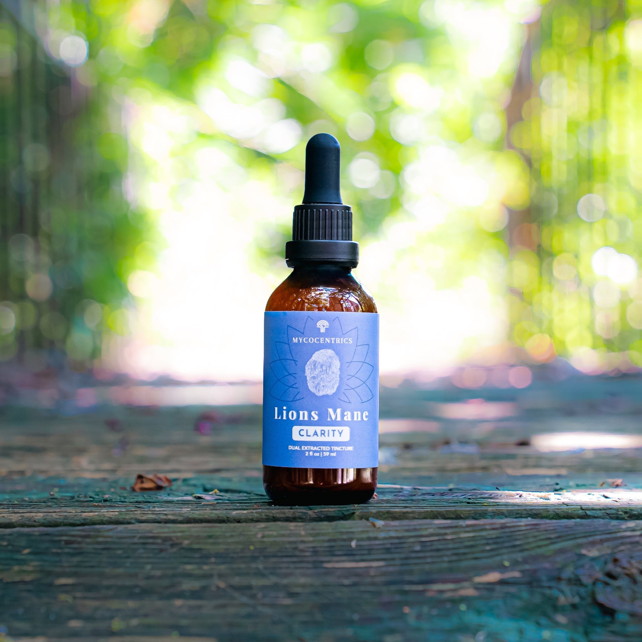 Mycocentrics Lion's Mane tincture bottle on a sunlit boardwalk