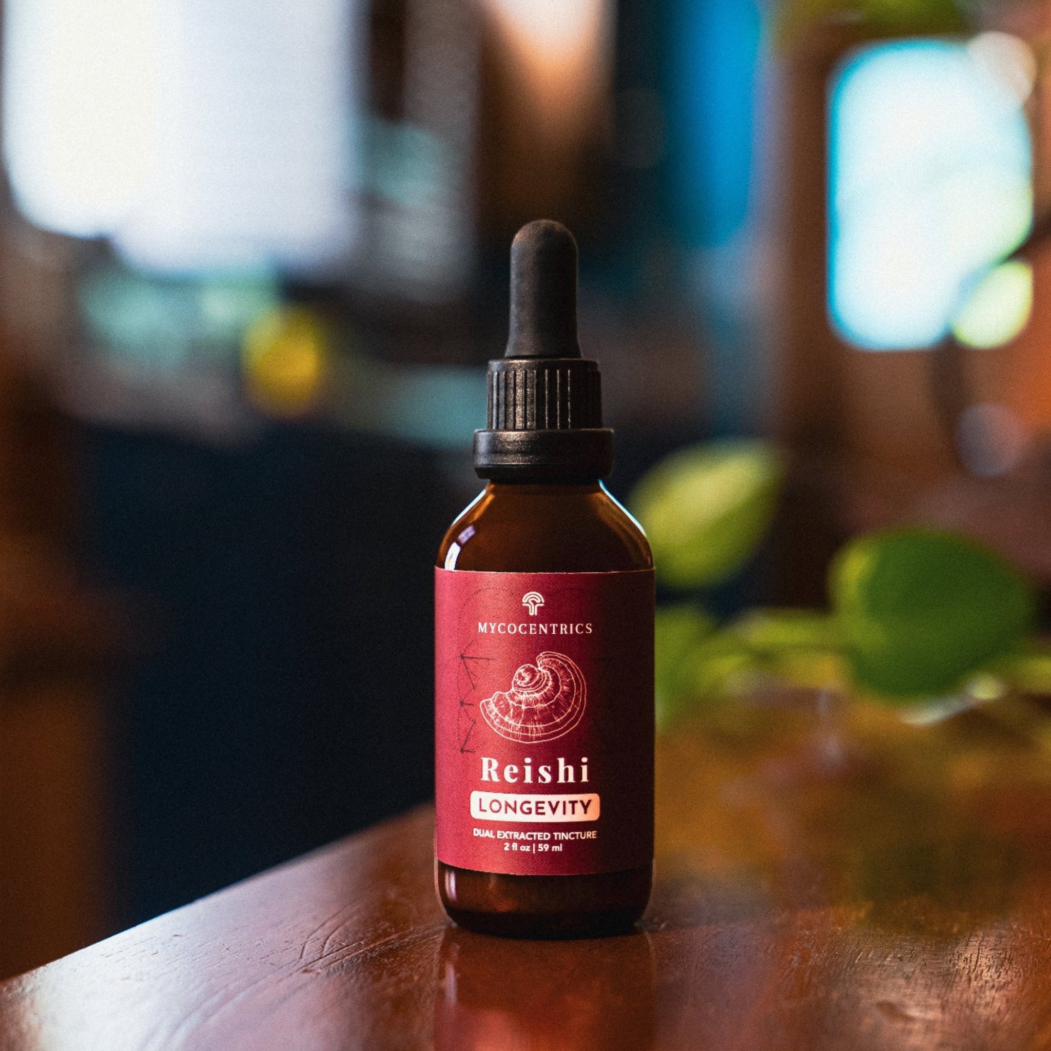 Mycocentrics Reishi Longevity tincture bottle on wood table