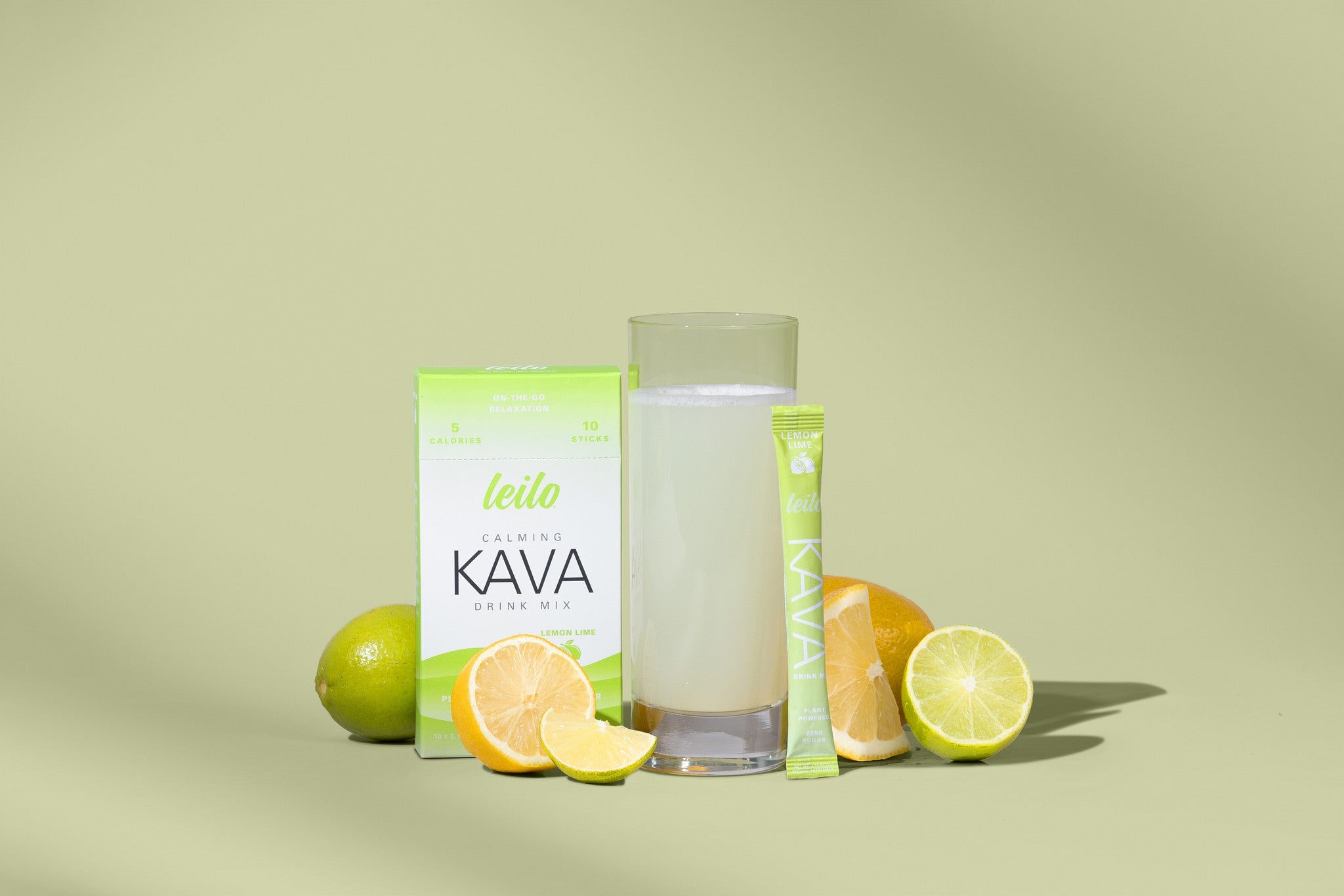 Leilo Kava Drink Mix | Lemon Lime lifestyle with glass, limes and lemons