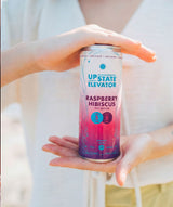 Upstate Elevator Raspberry Hibiscus can in hands