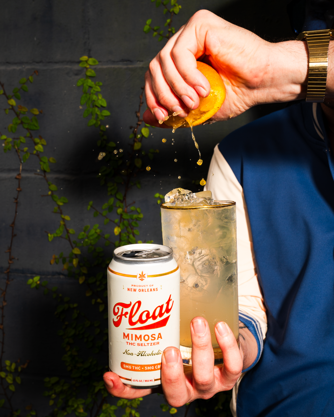 Float Mimosa THC Seltzer can beside a garnished cocktail