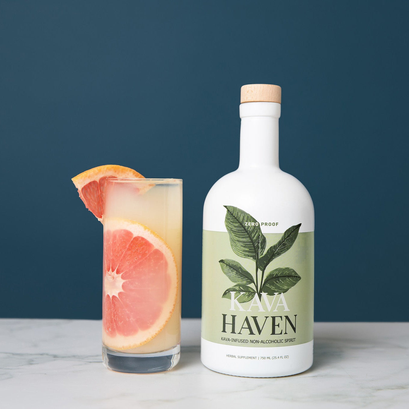 Kava Haven non-alcoholic spirit bottle beside a grapefruit mocktail