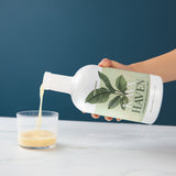 Pouring Kava Haven non-alcoholic spirit into a rocks glass